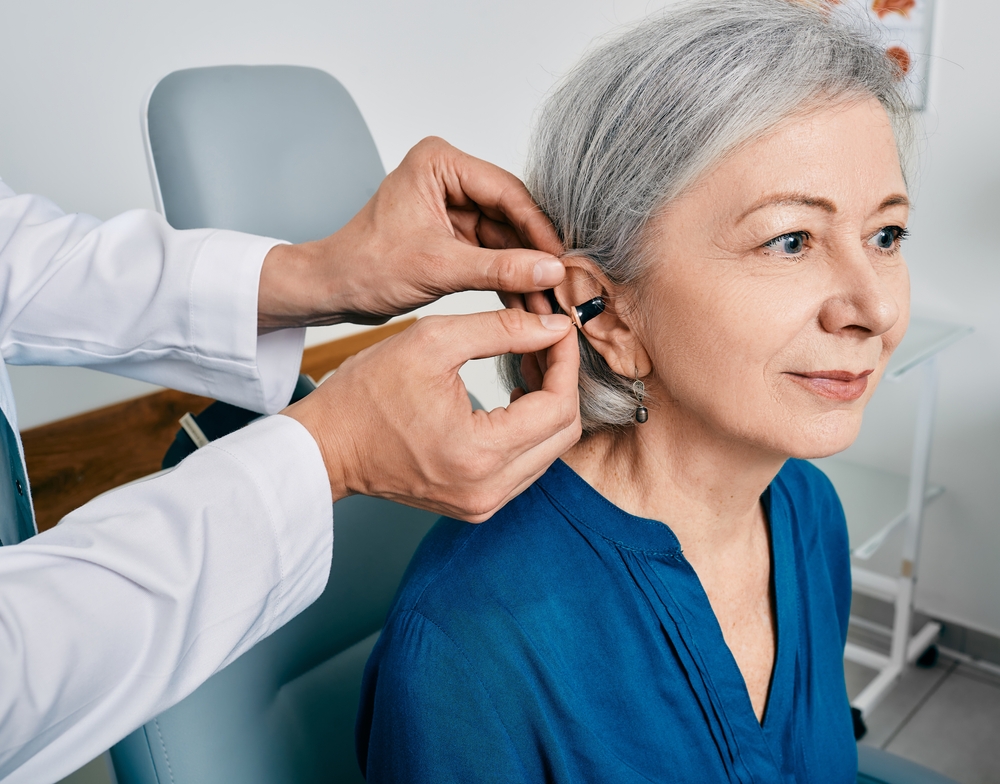 senior woman during a hearing aid installation